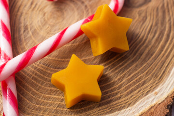 Candy Canes Detail and Star Beeswaxes on Wooden Surface