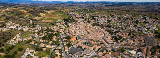 An aerial panoramic view around the old town of the city Paulhan in France on a sunny day in early spring