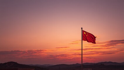 Chinese flag waving at sunset over hills
