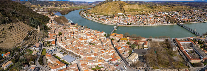 An aerial panoramic view around the old town of the city Tournon-sur-Rhône in France on a sunny day in early spring