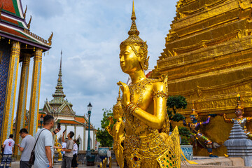 Golden angel statue with buddhist pagoda Wat Phra Kaew emerald temple