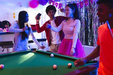 Naklejka premium Teenagers celebrating at party, dancing and playing pool with joyful expressions