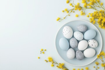 Pastel easter eggs decorated with dots and patterns surrounded by yellow mimosa flowers on a soft blue background