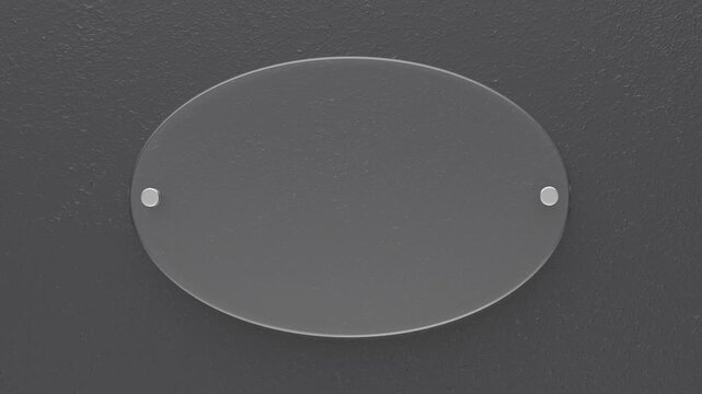 Transparent oval glass nameplate on dark grey wall