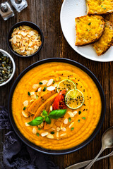 Pumpkin cream soup on wooden table	