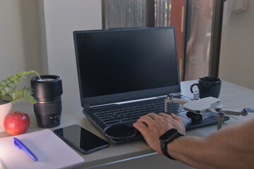 Work setup, with laptop, photography equipment, coffee and lunch