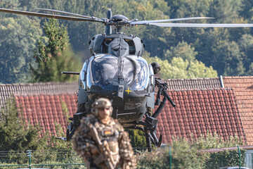 A German Bundeswehr Airbus H145 combat helicopter flies during a NATO exercise, showcasing modern military aviation, strength, and readiness for tactical operations in international defense. © Thomas