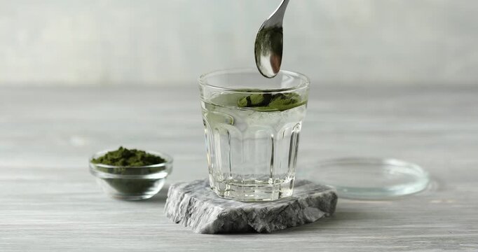 Chlorella algae powder dissolved in water in a glass