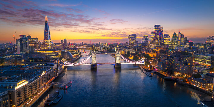 London City Skyline with Tower Bridge Illuminated at Sunset Aerial Panorama, England, United Kingdom