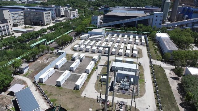 Aerial view of numerous white containers arranged on an open field