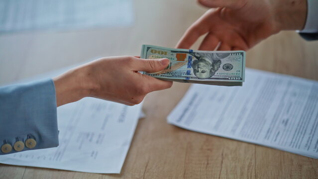 People hands exchanging money bribery at office closeup. Corporate corruption