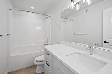 Bathroom with a white toilet, sink, and bathtub