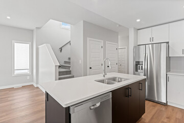 Kitchen with a stainless steel refrigerator and sink