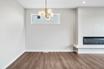Large room with a fireplace and a chandelier hanging from the ceiling