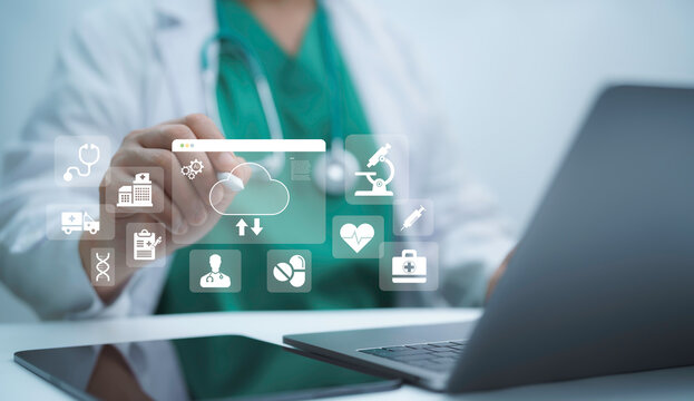 Medical professional interacting with digital healthcare icons on laptop and tablet, cloud storage, telemedicine, data security and innovation concept for modern online medical services - Powered by Adobe