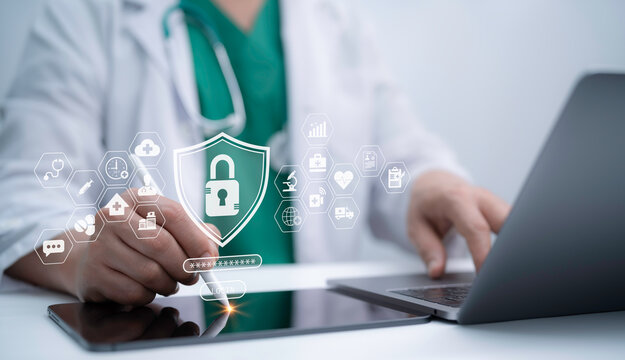 Doctor using laptop and tablet with digital healthcare security system, data protection, cloud service and innovation technology concept for safe telemedicine and online patient care