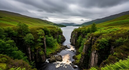 Serene valley landscape with river flowing through lush green hills.