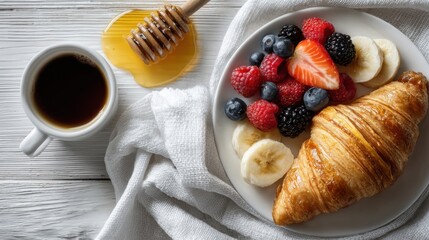 Breakfast with croissant fresh berries banana and honey