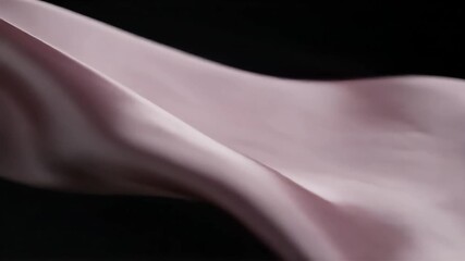 Ethereal flowing silk fabric catches the light, creating soft shadows and graceful movement against a dark backdrop, ideal for luxury brands and elegant designs - Powered by Adobe