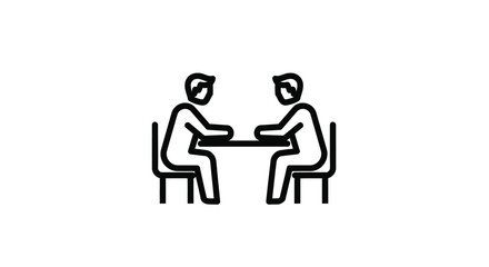 Two People Sitting at a Table Discussing Ideas