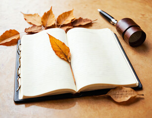 Pen and dried leaves kept on an open notepad or diary with white pages, creativity concept.