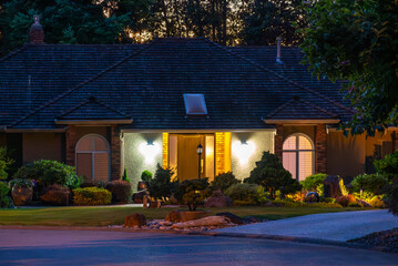 Two story stucco luxury house with big tree and nice landscape at night at Summer in Vancouver,...