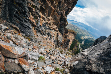 Steep cliff rocks leading to a high mountain top landscape
