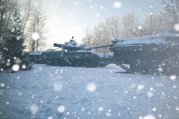 Military tank in a row. Battle tank in the snow on the roadside of highway. War in Ukraine in...