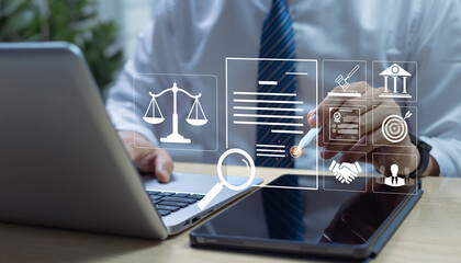 Businessman on laptop with virtual compliance icon, symbolizing enforcement of laws, regulations,...