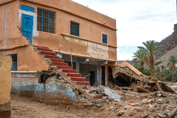 Flood damage in Oasis Igmir Morocco showing a partially destroyed traditional building and debris...