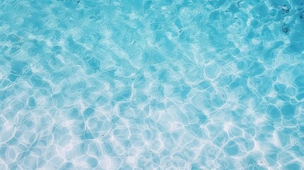 A serene, tranquil swimming pool with clear blue water and a gentle ripple effect, reflecting the sky above.