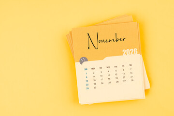 November 2026 calendar card on yellow color background with copy space.