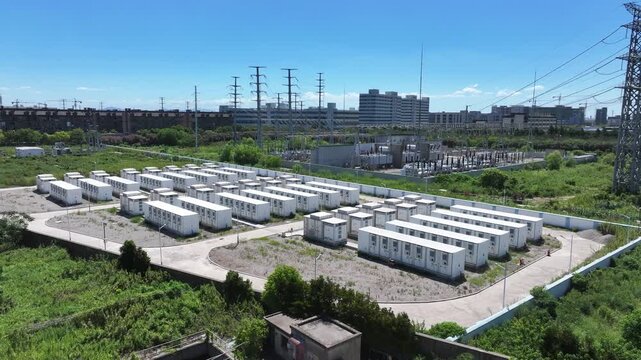 Aerial view of numerous white containers arranged on an open field