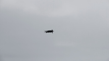 Drone against the sky. Copter in flight.