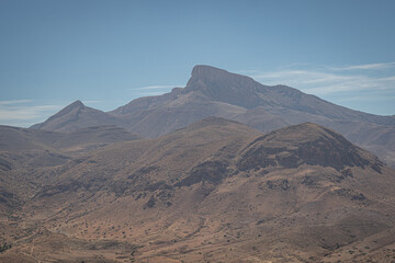 Rocky mountain peaks in northern Morocco with dry barren slopes and rugged terrain under clear blue sky creating vast panoramic desert landscape view