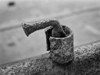 Closeup of a rusty detail of an old fence. Captured on a B&W film. Vintage style.