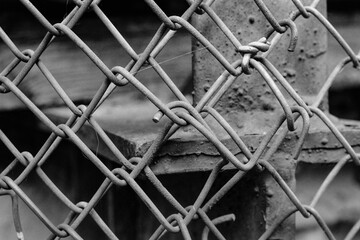Closeup of an old chain fence. Captured on a B&W film. Vintage style.