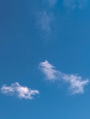 Minimalist Blue Sky with Small Wispy White Clouds