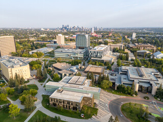 Aerial view of the University of Calgary campus with the city skyline in the distance. 