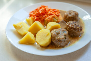 Dinner dish with potatoes, meatballs and carrots