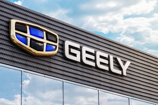 Krasnoyarsk, Russia , January 14, 2025: importance separated by commas without numbering: The logo of the automaker Geely on the facade of the dealership. Geely is a growing and powerful auto brand