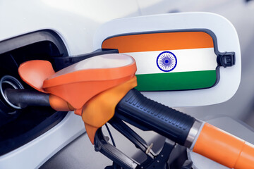 The flag of the Kingdom of India on the lid of the gas tank of a car at a gas station in close-up....