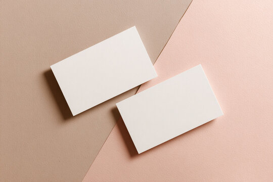A high quality photography of blank business card or shop card for mock-up and presentation. pastel beige and pink background.
