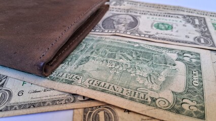 Leather wallet and us dollar bills