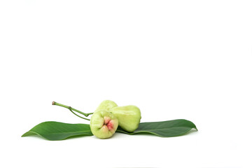 Two pale green water apples (jambu air) and a single leaf, arranged on a white background. The fruit is pear-shaped and shows a subtle pink blush.