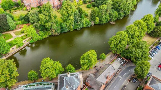An aerial view panning up towards the cathedral in the town of Lichfield, UK in summertime