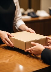 Employee handing a package to a customer at the counter.