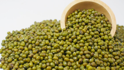 Close-up of mung beans spilling from a wooden bowl