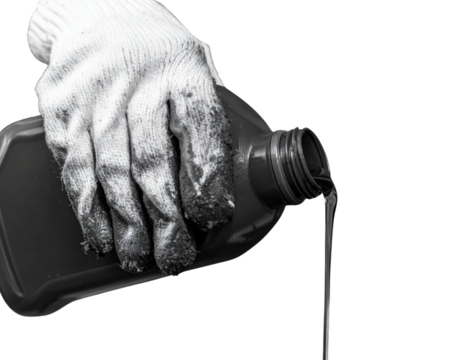 A gloved hand pours a dark liquid from a plastic bottle, showcasing a focus on the texture and motion of the substance.