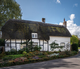 Traditional English village with thatched cottages.